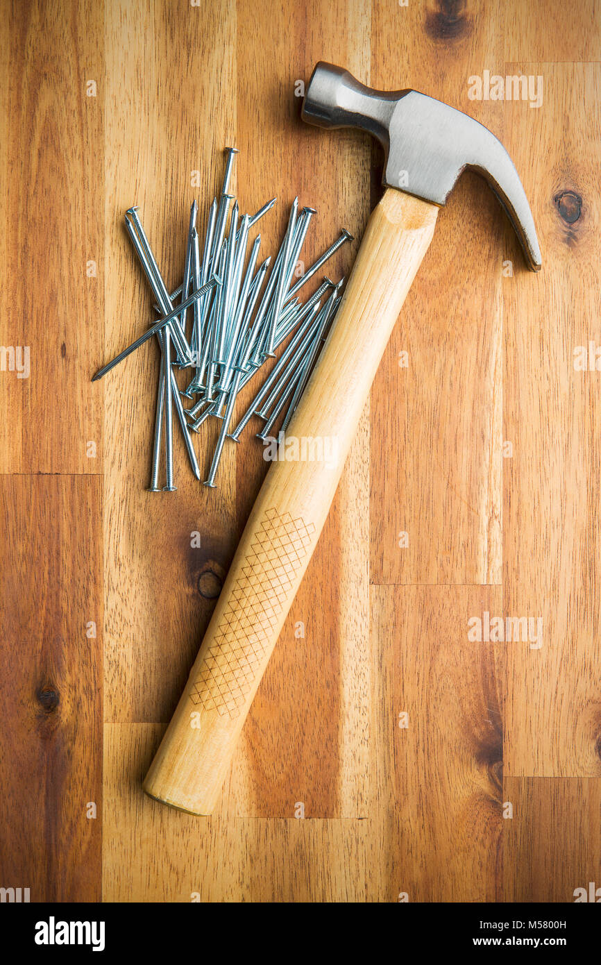 Hammer and nails on wooden table Stock Photo - Alamy